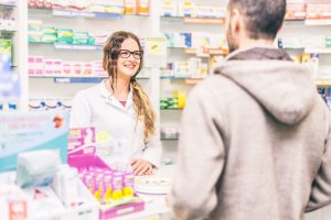 Pharmacist,Talking,With,A,Customer,At,The,Pharmacy,Desk
